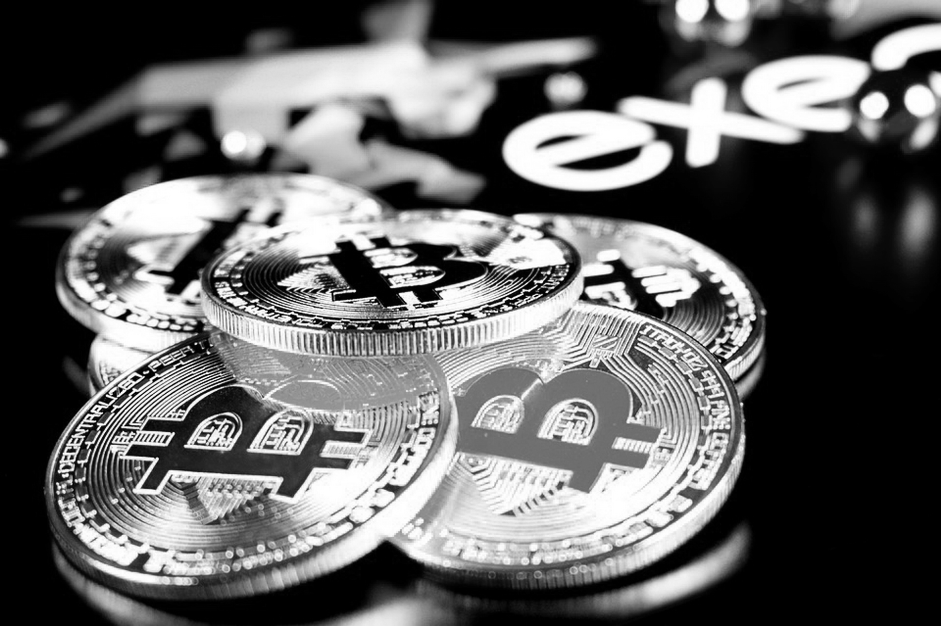 Crypto fund hero image of pile of bit coins with black and white filter